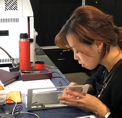 Woman repairing a tablet